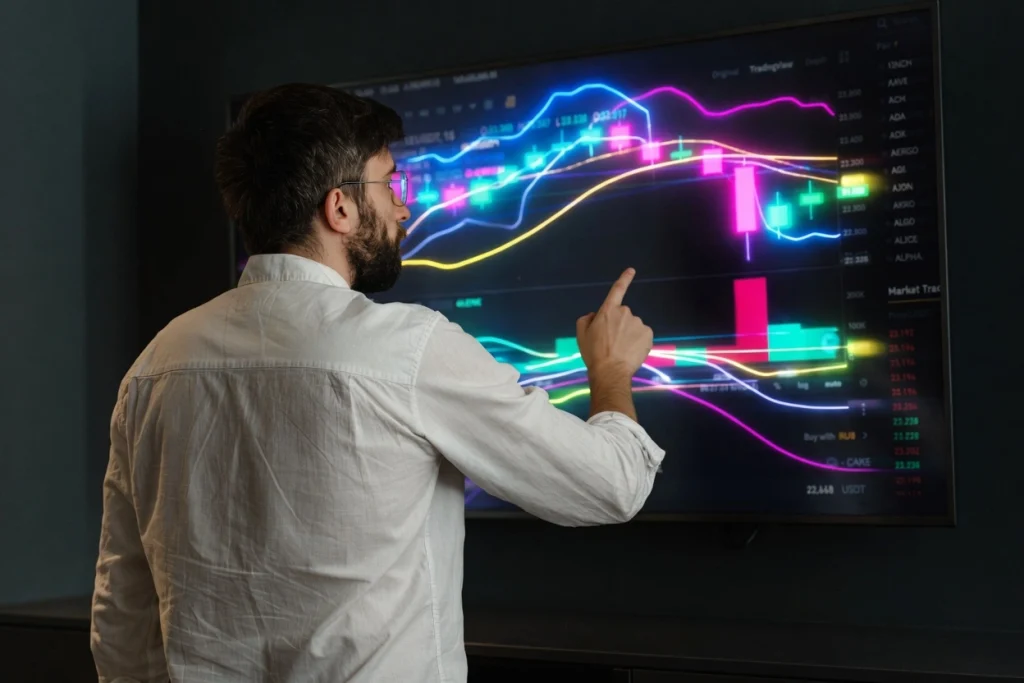 Risk Management for Crypto Traders: Focused trader analyzing real-time neon cryptocurrency charts and market data on large screen. 